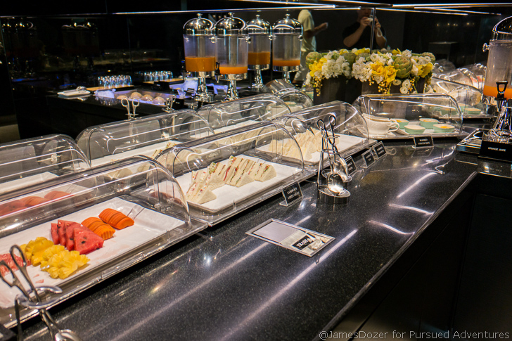 a buffet table with food in containers