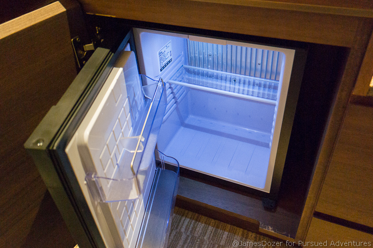 a small refrigerator with a light in the door