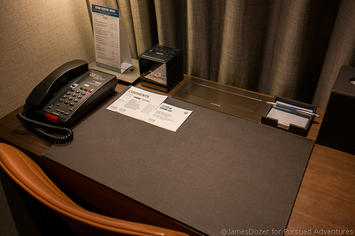a desk with a telephone and papers on it