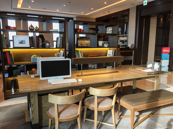 a desk with chairs and a computer