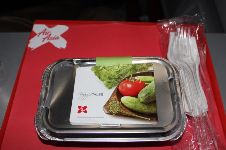 a tray with a label on it and plastic forks