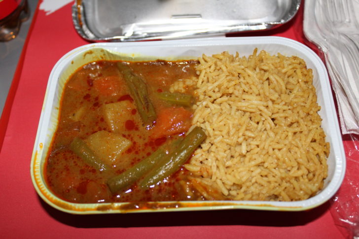 a container of food with rice and vegetables
