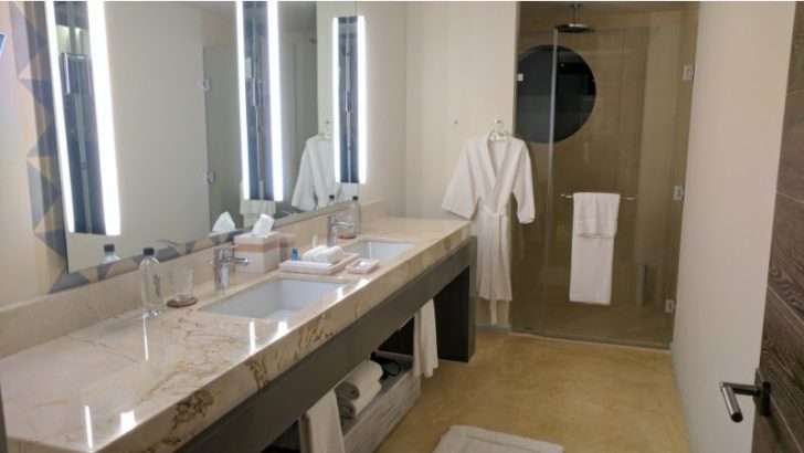 a bathroom with a marble countertop and a shower