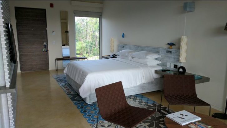 a bedroom with a bed and chairs