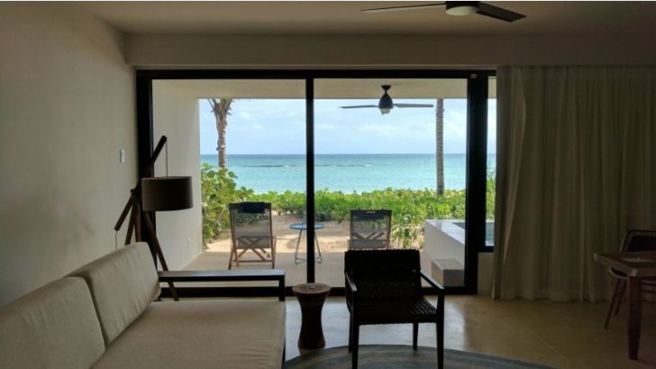 a living room with a view of the ocean