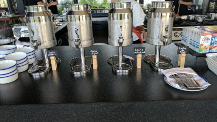 a group of silver containers on a black table