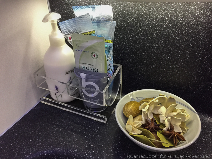 a bowl of food and a soap dispenser on a counter