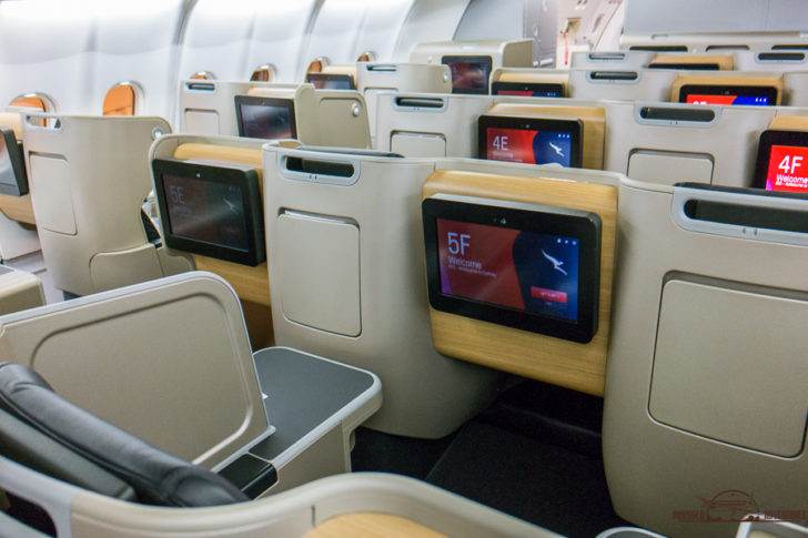 a row of seats with monitors on the back