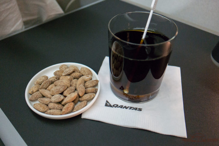 a plate of food and a glass of liquid on a napkin