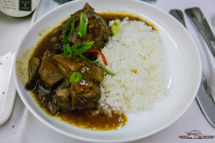 a plate of food with rice and meat