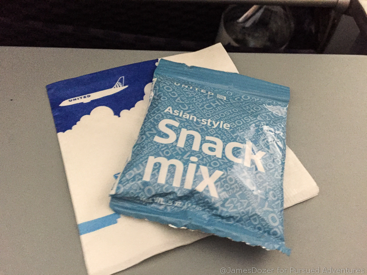a blue bag of snack mix on a napkin