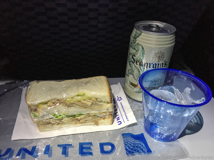 a sandwich and a can of soda