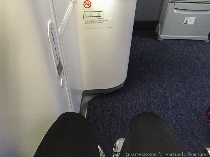 a person's legs in black pants and shoes