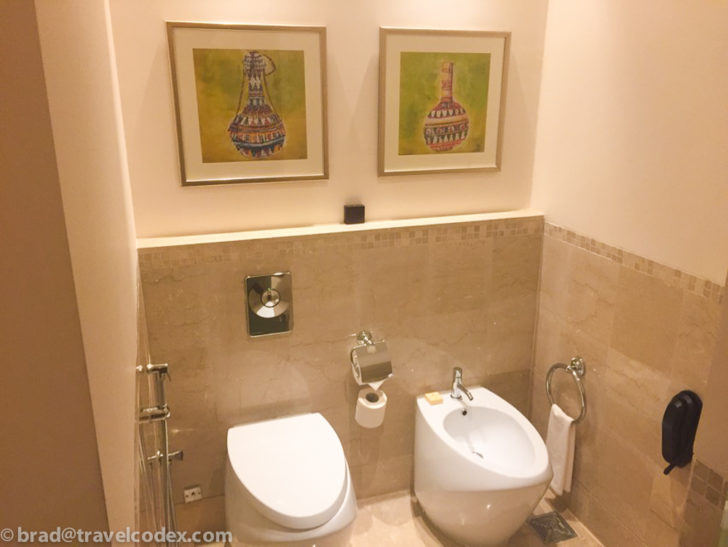 a bathroom with a toilet and a bidet