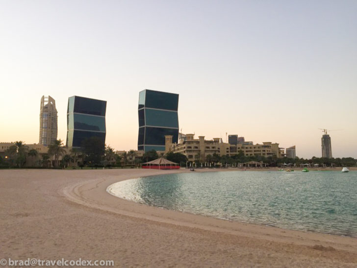a beach with buildings and a body of water