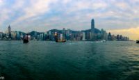 a city skyline with boats in the water