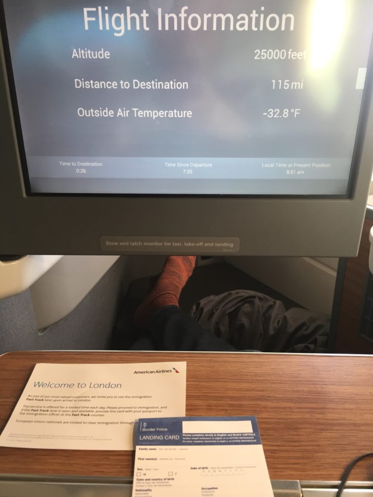a screen with a person's feet in the background