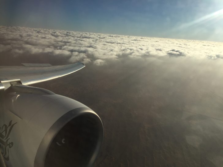 an airplane wing above clouds