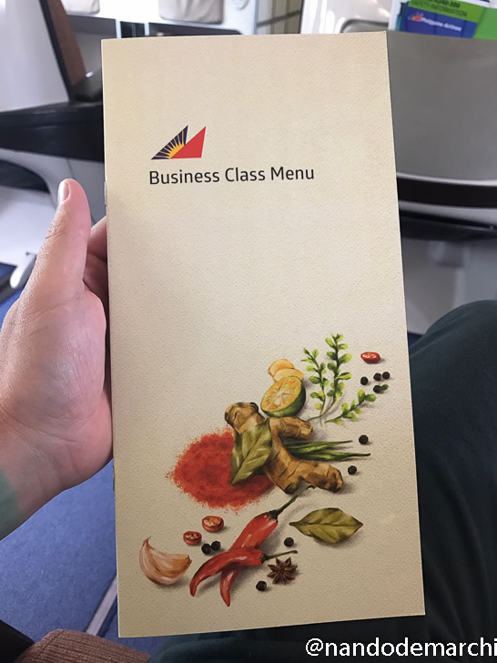a hand holding a menu