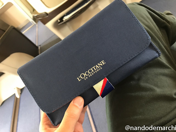 a hand holding a blue wallet
