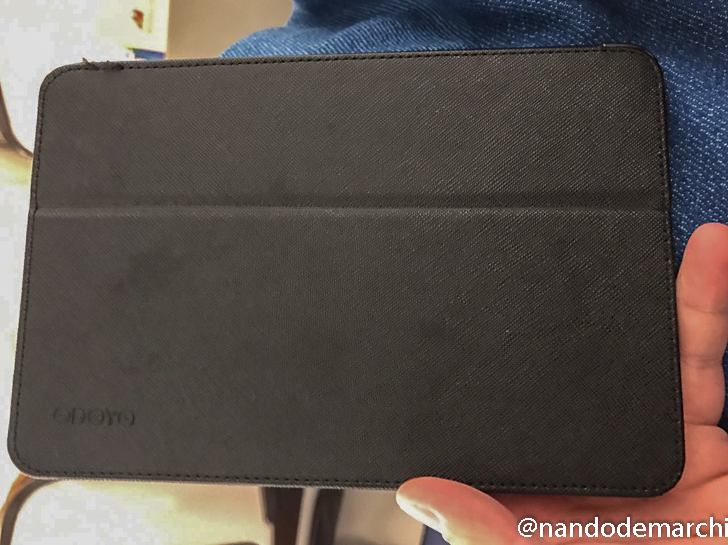 a hand holding a black tablet case