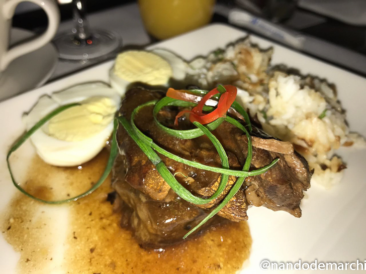 a plate of food with a glass of wine