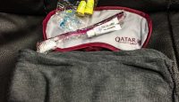 a towel and a toothbrush on a black couch