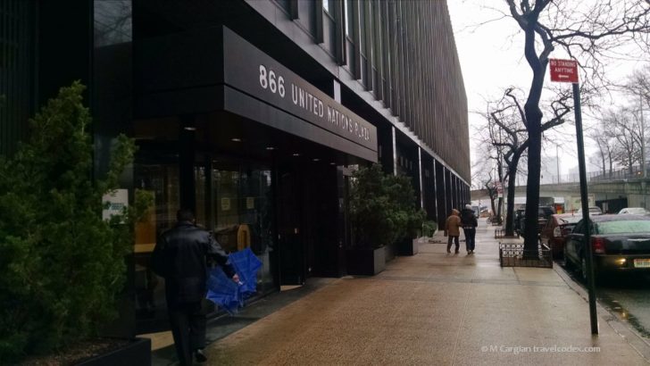 a man holding an umbrella in front of a building