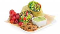 a plate of food with a bowl of dip and a cookie