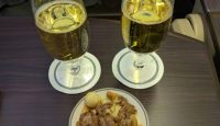 a plate of food and a couple glasses of beer