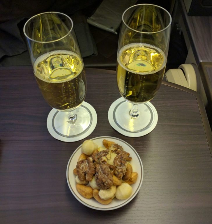 a plate of food and a couple glasses of beer