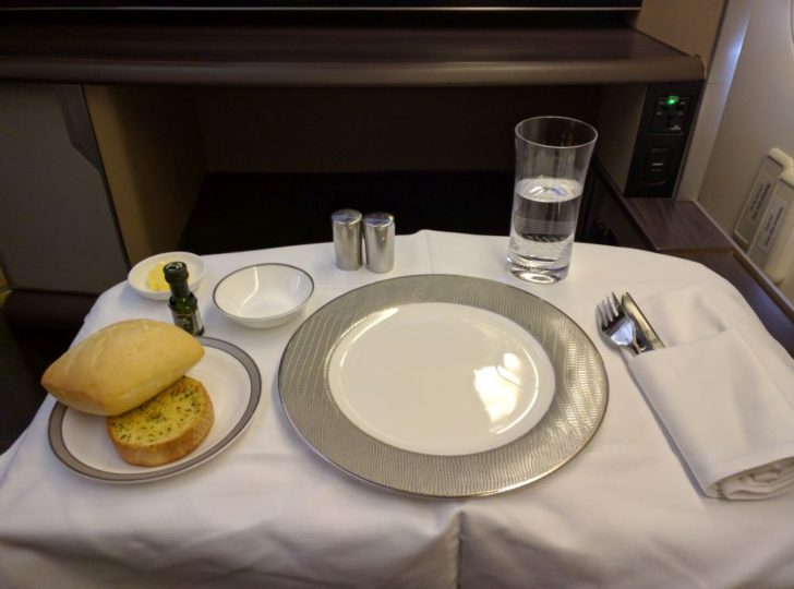a plate with food on it and a glass of water on a table