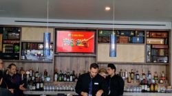 a group of people standing at a bar