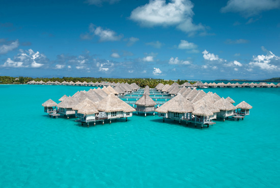 a group of huts on stilts in the water