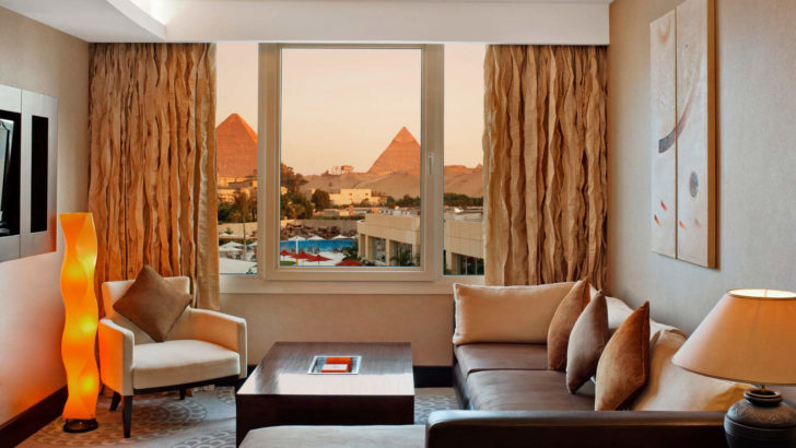 a room with a couch and chairs