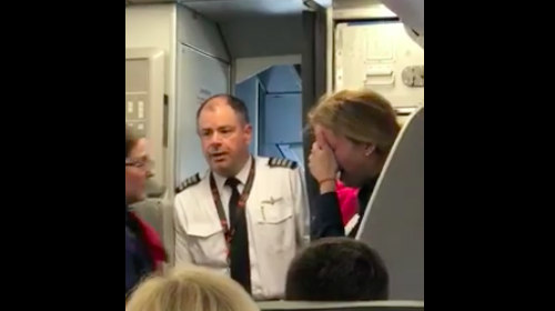 a man in a uniform with a woman in the back