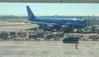 a blue airplane on the tarmac