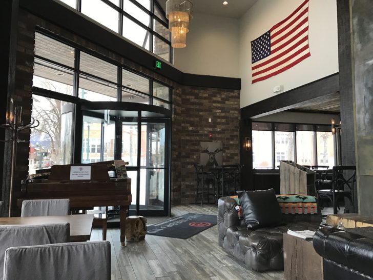 a room with a piano and a flag on the wall