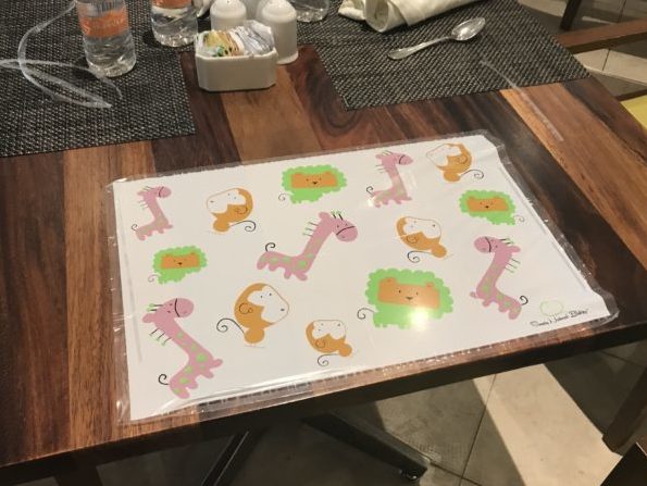a table with a place mat and a spoon