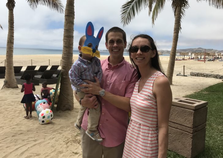 a man and woman holding a child