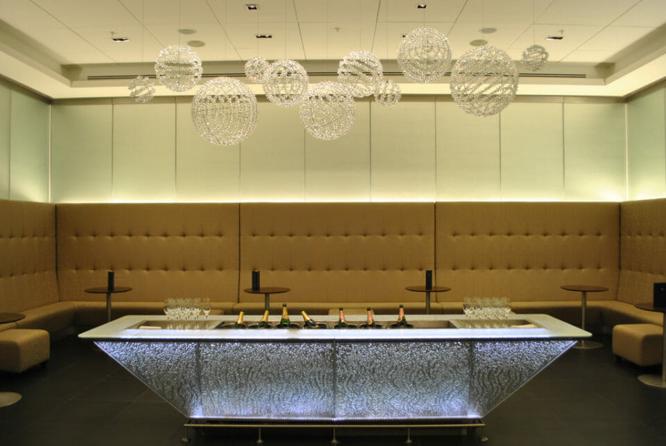 a long table with wine glasses and a chandelier