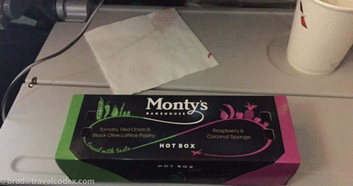 a black box with green and pink text on a silver surface