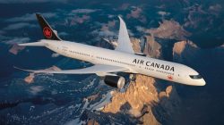 a plane flying over mountains