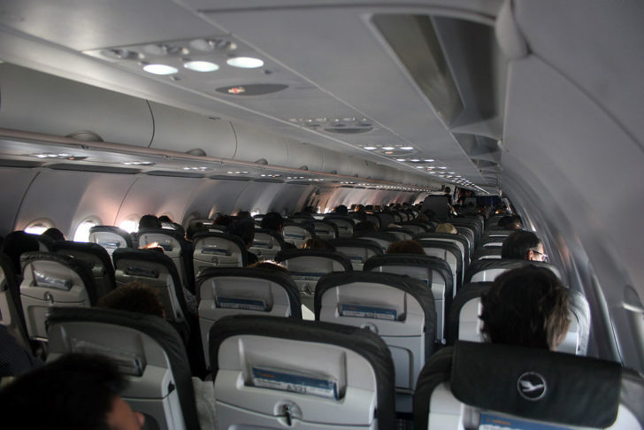 a group of people sitting in an airplane