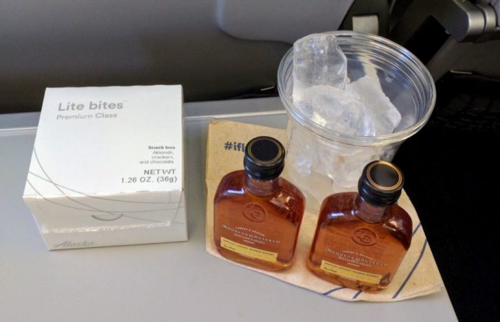 two bottles of alcohol next to a glass of ice