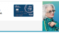 a woman smiling and holding a credit card