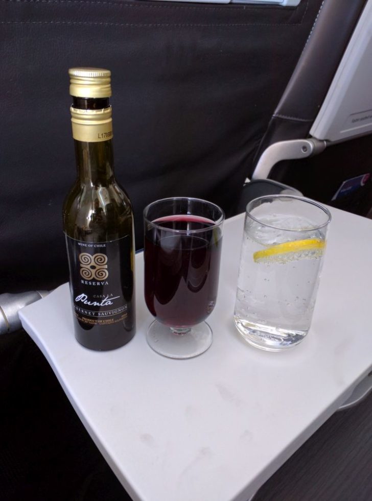 a bottle and a glass of liquid on a table