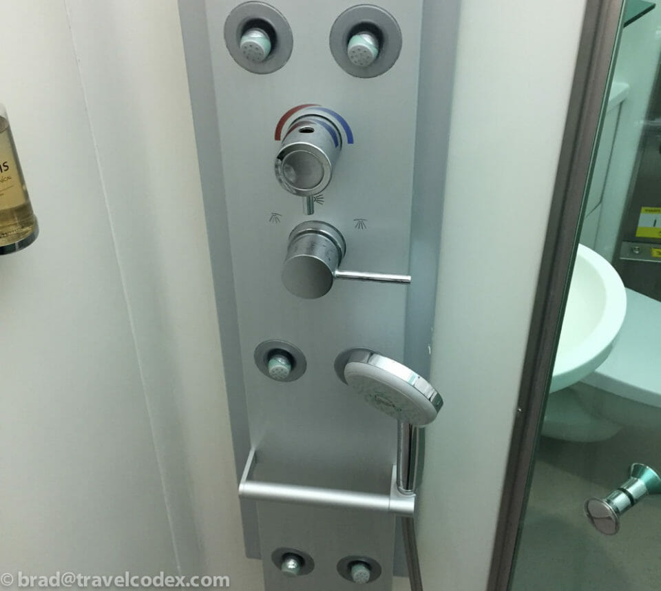 a shower head with knobs and a shower head