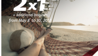 a person's legs in a hammock on a beach