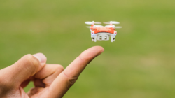 a person's hand holding a small drone